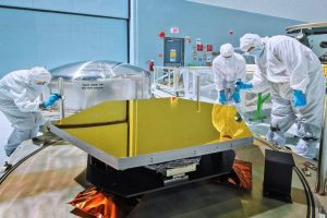 employees in white lab coats inspecting DI water tank