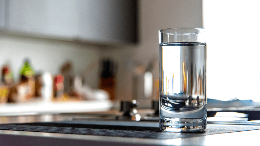 clear glass of water sitting on a kitchen counter