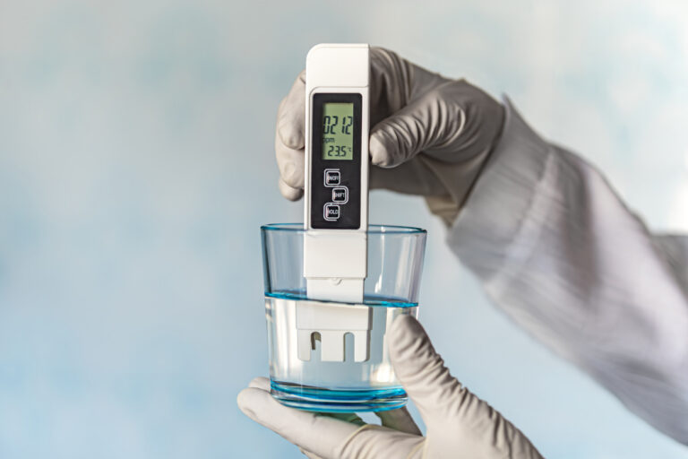 pH meter in hands with gloves,